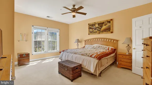 a bedroom with a large bed and a dresser