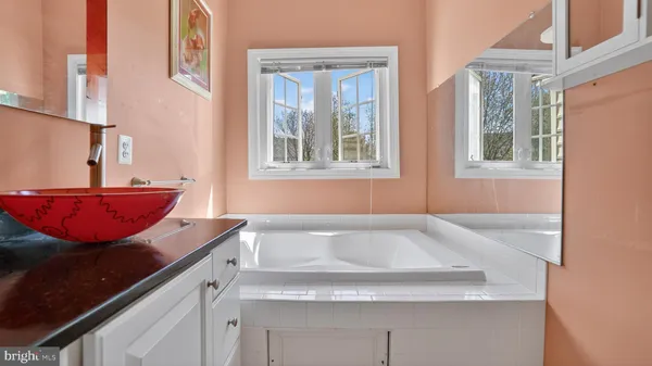 a bathroom with a granite countertop toilet and a sink