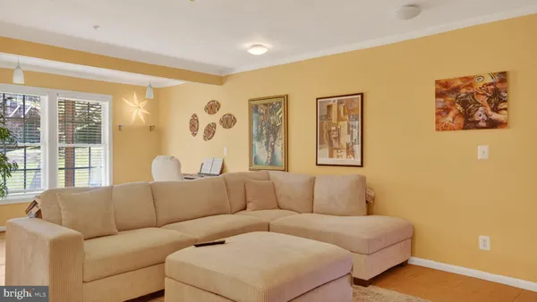 a living room with furniture and large windows