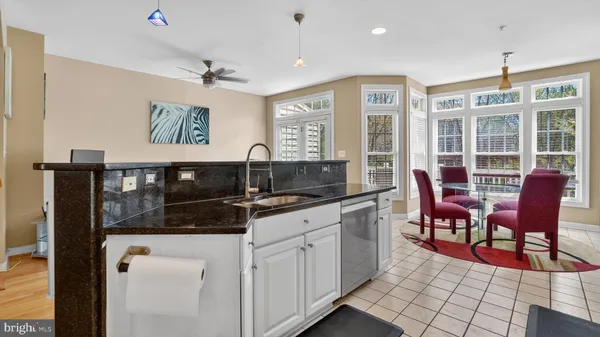 a kitchen with stainless steel appliances a refrigerator sink and microwave