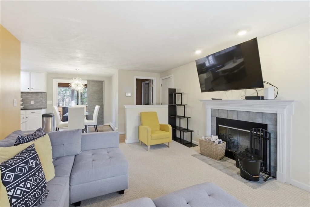 133 Grove Street Bellingham, MA 02019 - Photo 17 of 42 a living room with furniture fireplace and flat screen tv