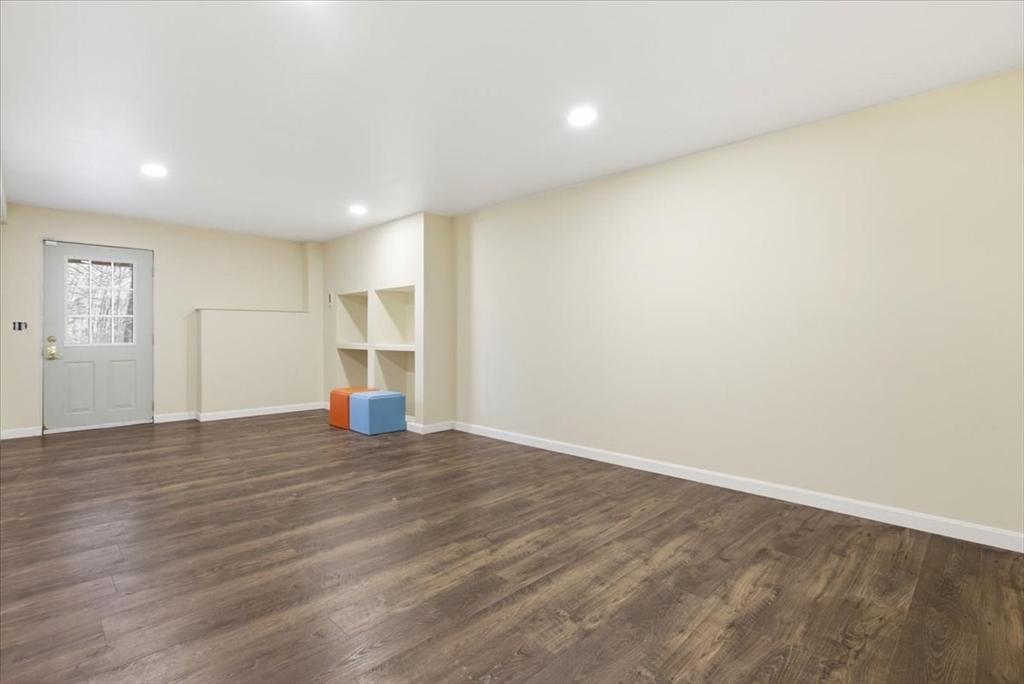 133 Grove Street Bellingham, MA 02019 - Photo 19 of 42 a view of an empty room with wooden floor and windows