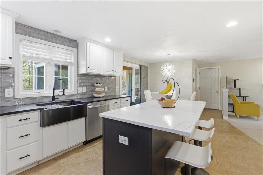 133 Grove Street Bellingham, MA 02019 - Photo 2 of 42 a kitchen with a sink a stove and cabinets