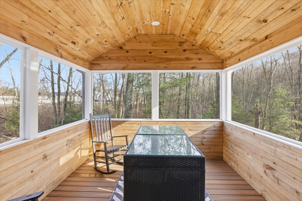 133 Grove Street Bellingham, MA 02019 - Photo 26 of 42 a view of a patio with a table chairs and wooden floor