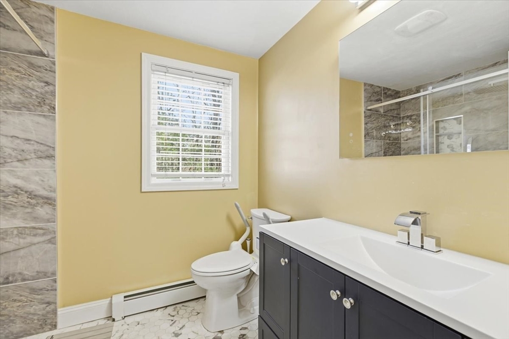 133 Grove Street Bellingham, MA 02019 - Photo 27 of 42 a bathroom with a sink a toilet and a mirror
