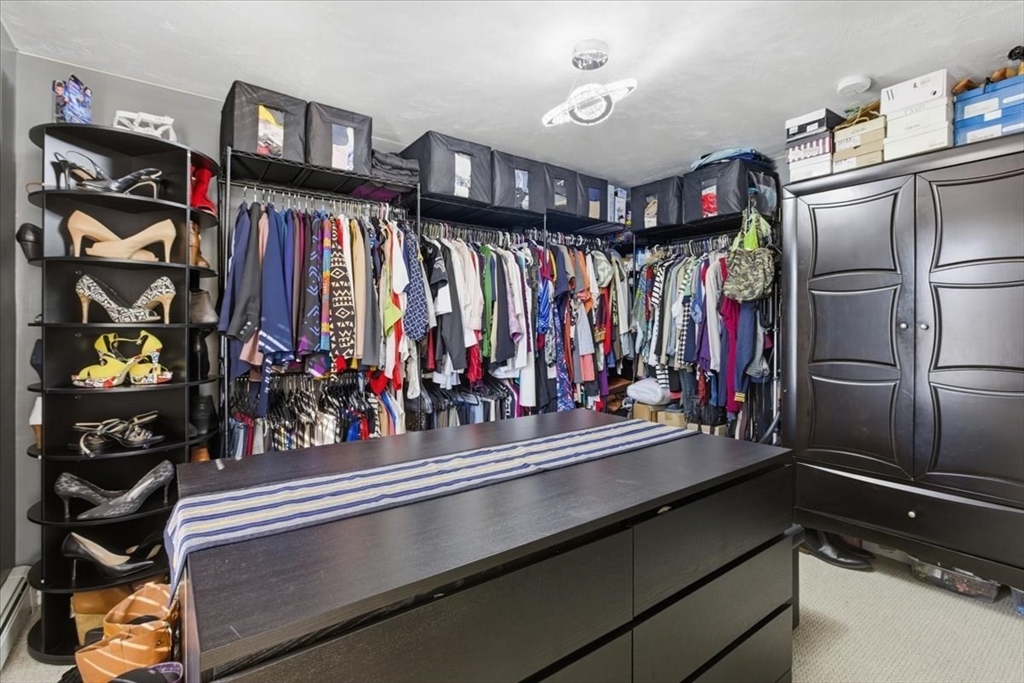 133 Grove Street Bellingham, MA 02019 - Photo 28 of 42 a kitchen with lots of bottles of alcohol