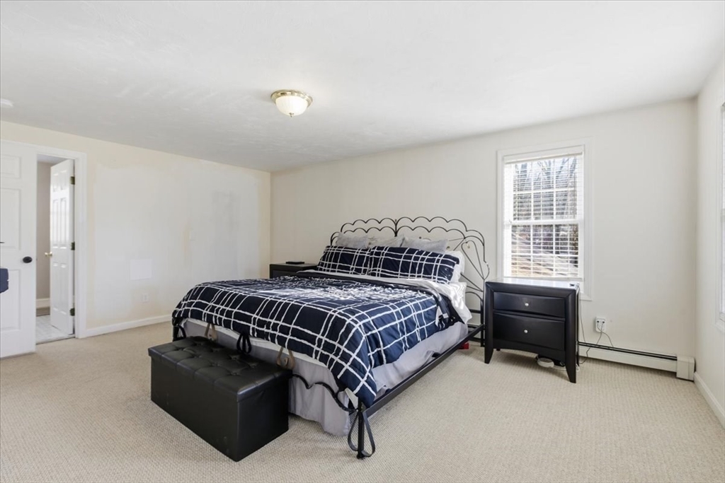 133 Grove Street Bellingham, MA 02019 - Photo 29 of 42 a bedroom with a bed and a dresser