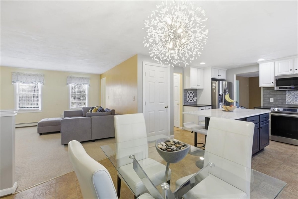 133 Grove Street Bellingham, MA 02019 - Photo 4 of 42 a living room with furniture and a chandelier