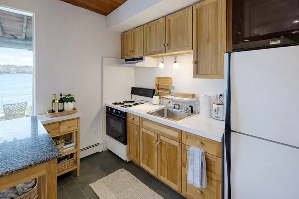 a kitchen with stainless steel appliances granite countertop a sink stove and cabinets
