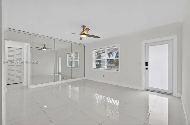 a view of empty room with windows and cabinet