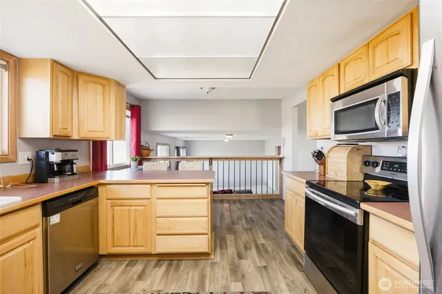 a kitchen with a sink stove top oven and microwave
