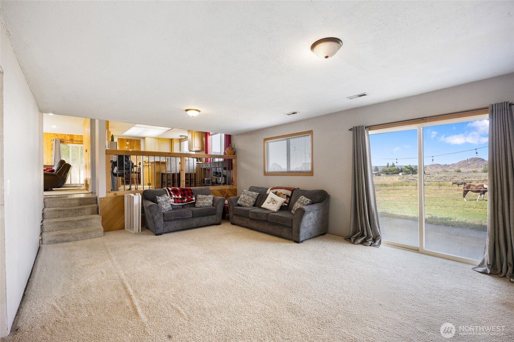 55790 Lake Ridge Lane Electric City, WA 99123 - Photo 14 of 35 a living room with furniture and a large window