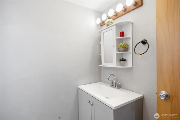 a bathroom with a sink vanity and a mirror