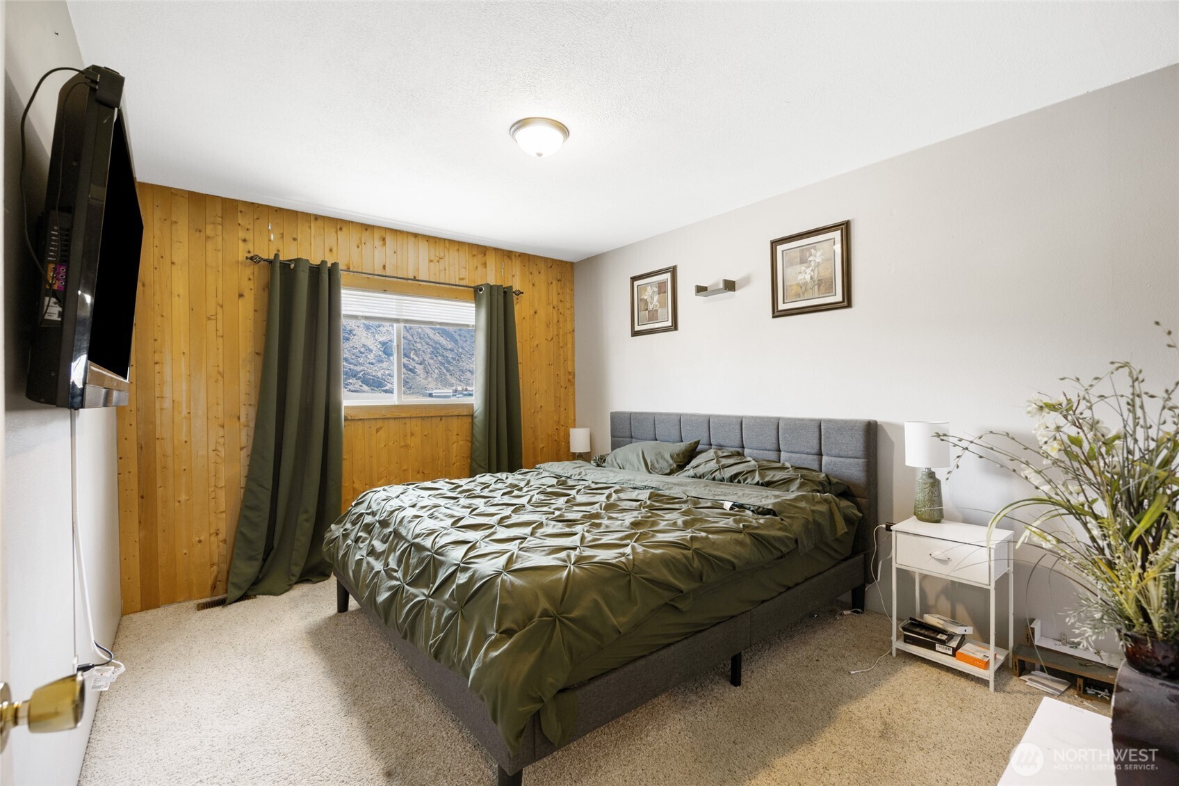55790 Lake Ridge Lane Electric City, WA 99123 - Photo 23 of 35 a bedroom with a bed and a potted plant next to a window