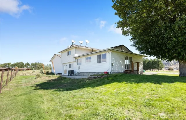 a view of a house with a yard and lake view