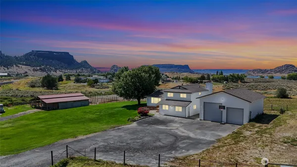 a view of house with backyard and a garden