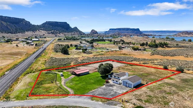 a view of swimming pool with a yard and mountain view in back