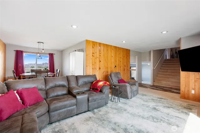 a living room with furniture window and a flat screen tv