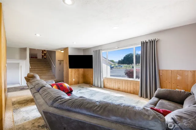 a living room with furniture and a flat screen tv