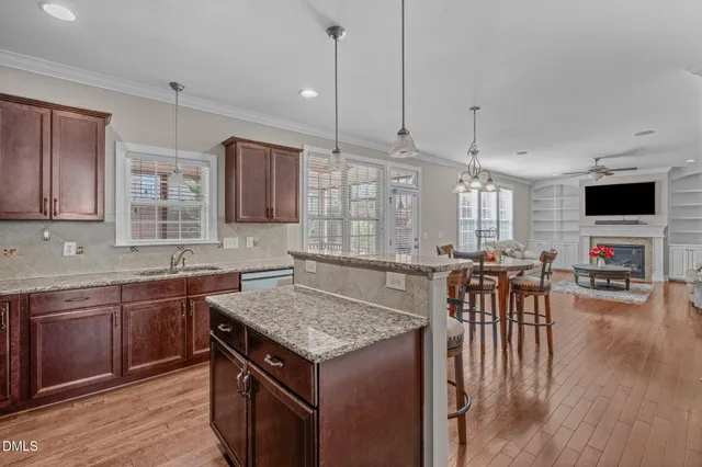 a view of a dining room with furniture wooden floor and a chandelier