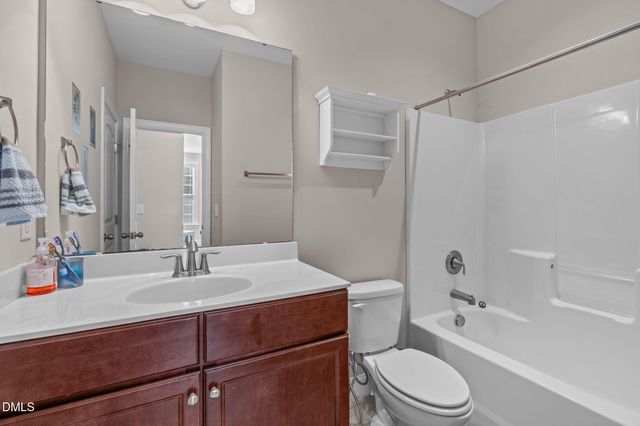 a view of staircase with railing and white walls