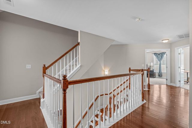 a spacious bedroom with a bed and a chandelier