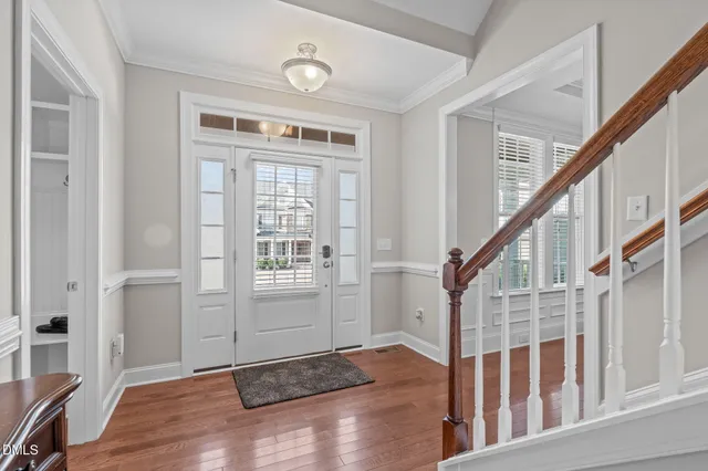 a view of a hallway with wooden floor and a fireplace