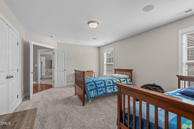 a bathroom with double vanity sinks a vanity two mirror and a shower