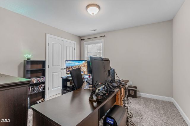 a bedroom with furniture and a flat screen tv