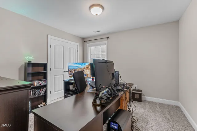 a bedroom with furniture and a flat screen tv