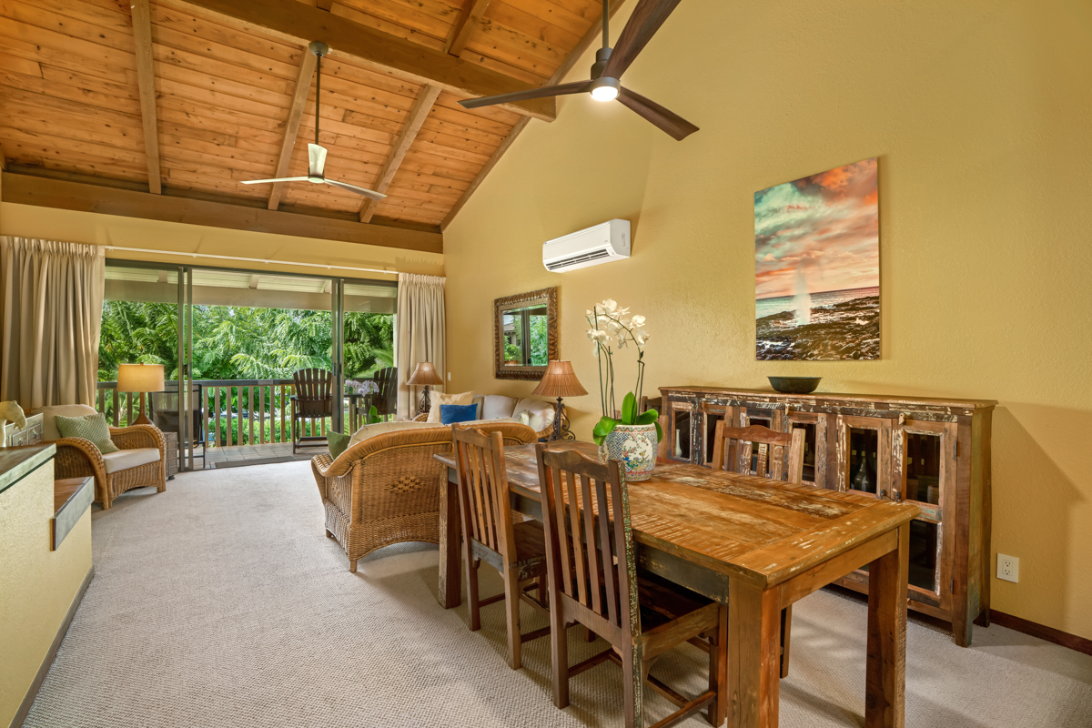 1870 Hoone Road, Unit 602 Koloa, HI 96756 - Photo 6 of 22 a dining room with furniture a rug and a large window