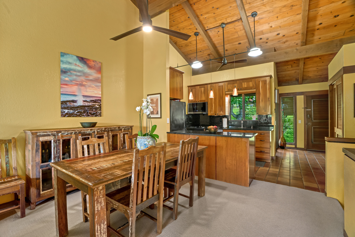 1870 Hoone Road, Unit 602 Koloa, HI 96756 - Photo 7 of 22 a dining room with furniture a chandelier and window