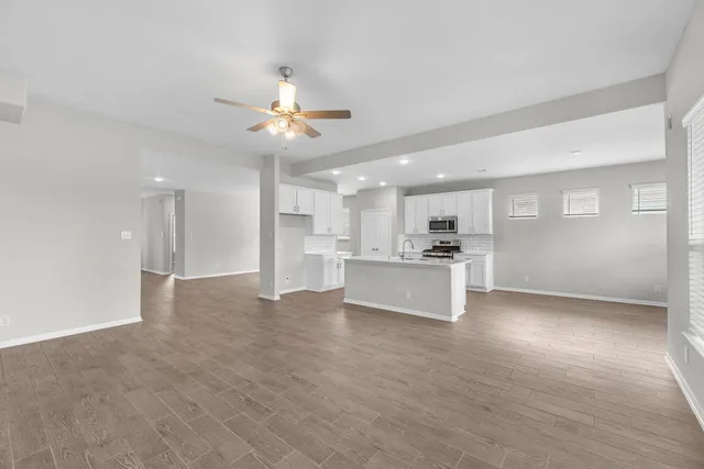 a view of kitchen with kitchen island white cabinets and refrigerator