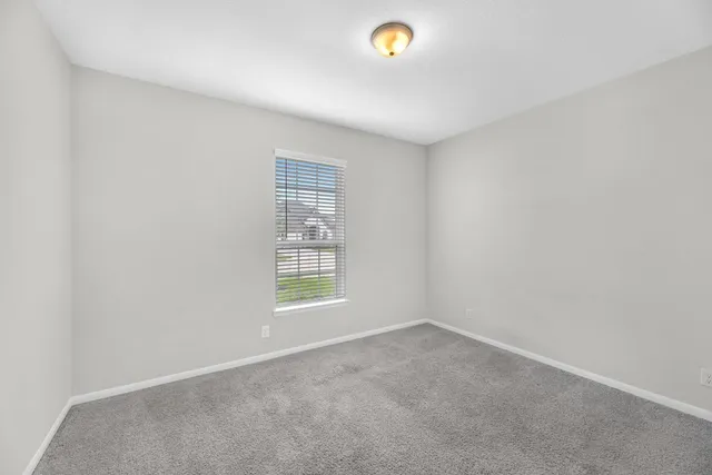 an empty room with a empty space and window