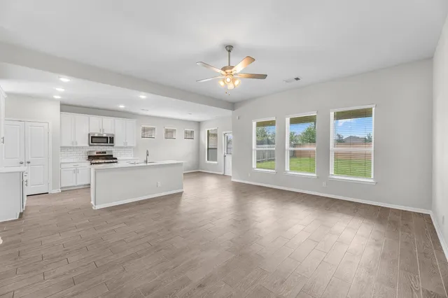 a view of kitchen with sink and refrigerator