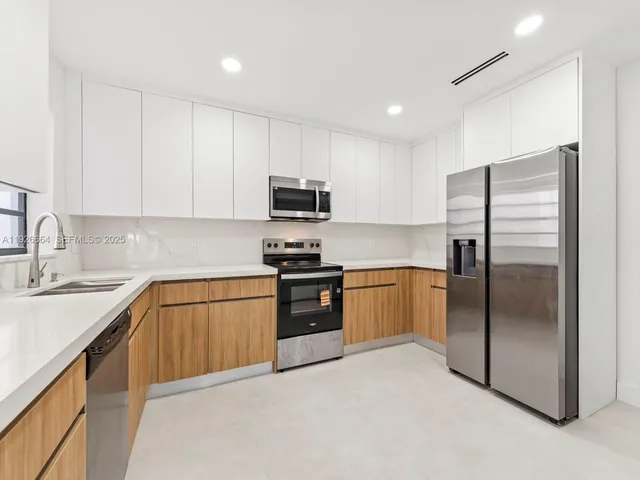 a kitchen with a refrigerator sink and microwave