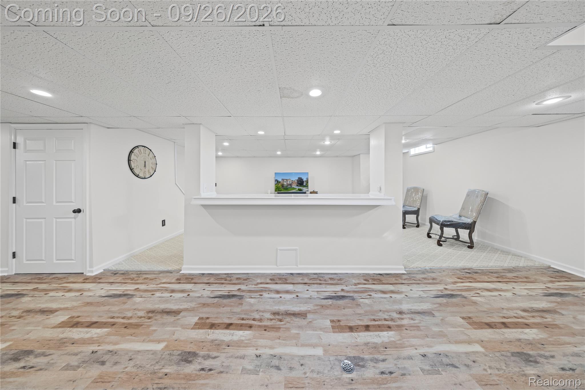 7021 Fox Path Canton, MI 48187 - Photo 7 of 59 Wood-finish flooring, recessed lighting, drop ceiling, white paneled door, and a built-in half-wall structure