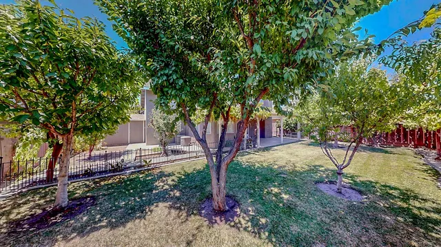 an aerial view of a house with a yard and garden