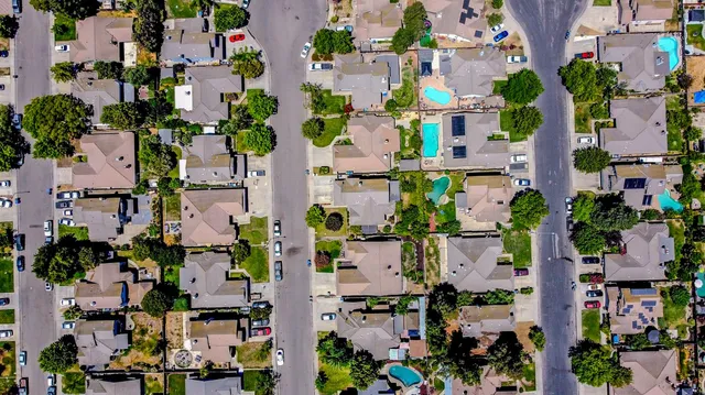 an aerial view of a house with outdoor space