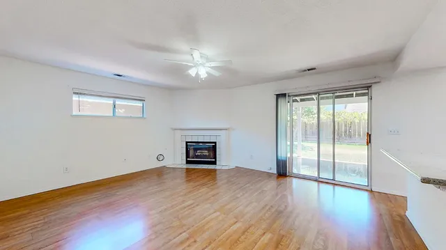 a view of a kitchen with an empty space and a ceiling fan