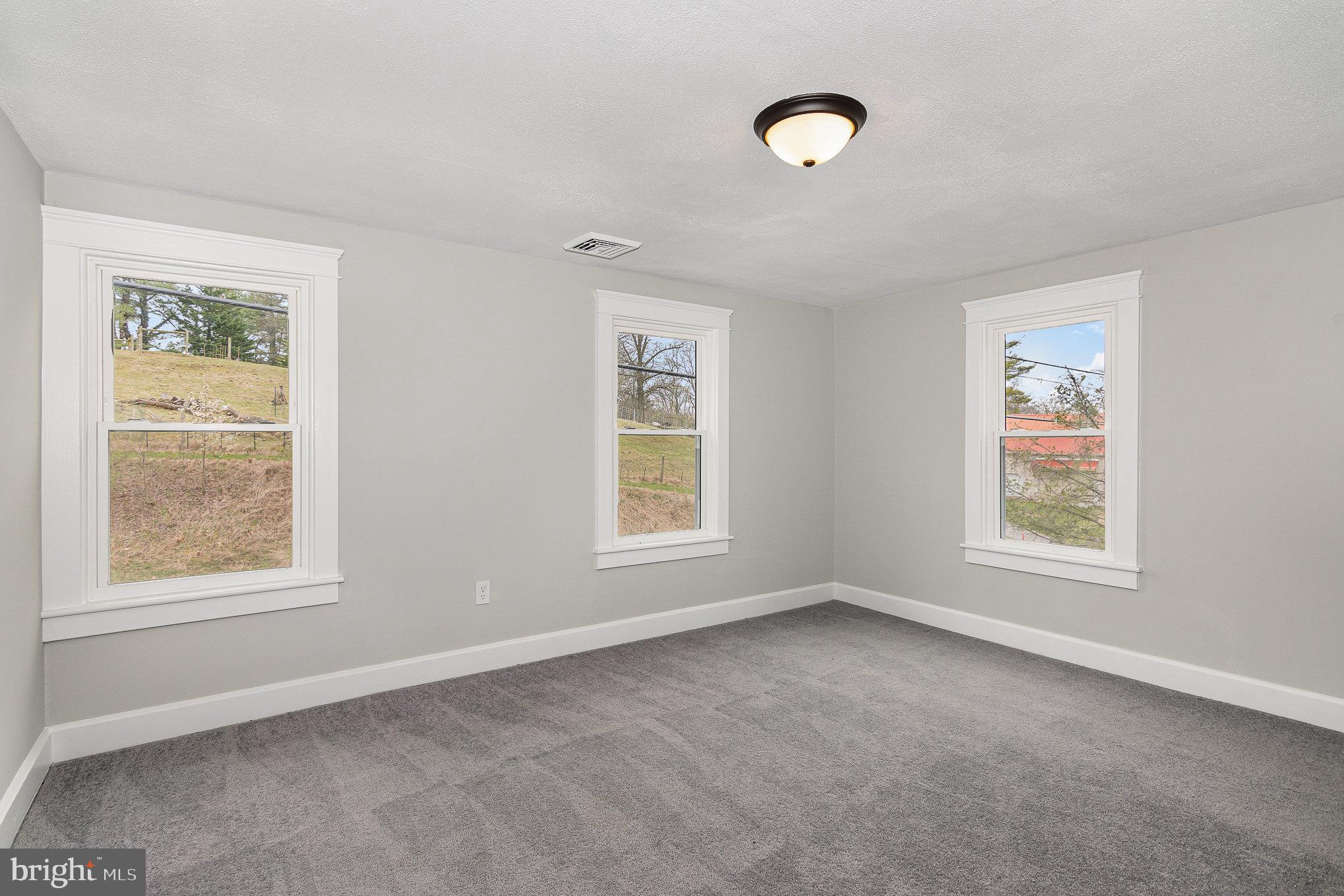 5495 Lehman Road Spring Grove, PA 17362 - Photo 15 of 34 a view of an empty room with a window and wooden floor
