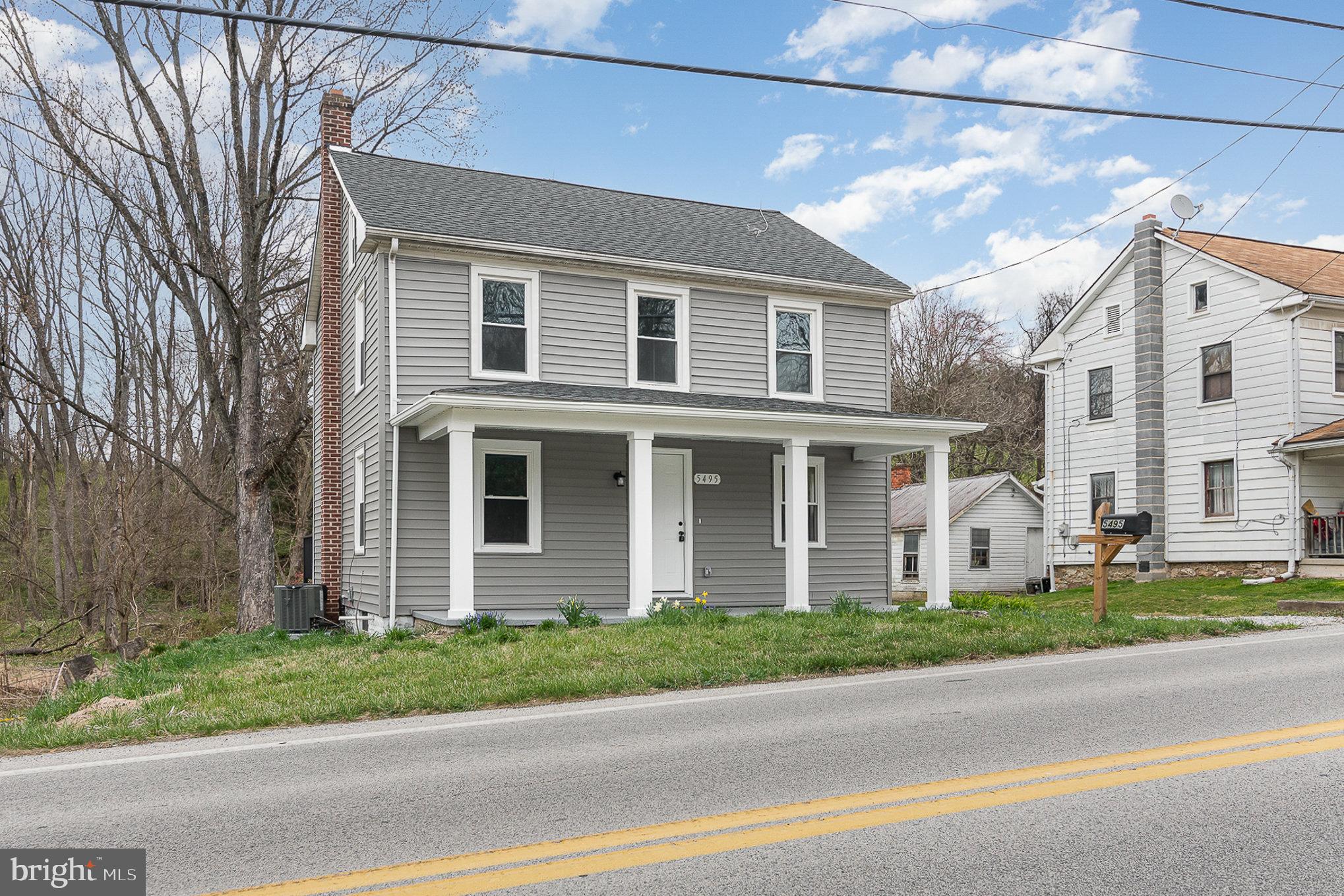 5495 Lehman Road Spring Grove, PA 17362 - Photo 2 of 34 a front view of a house with a garden and garage