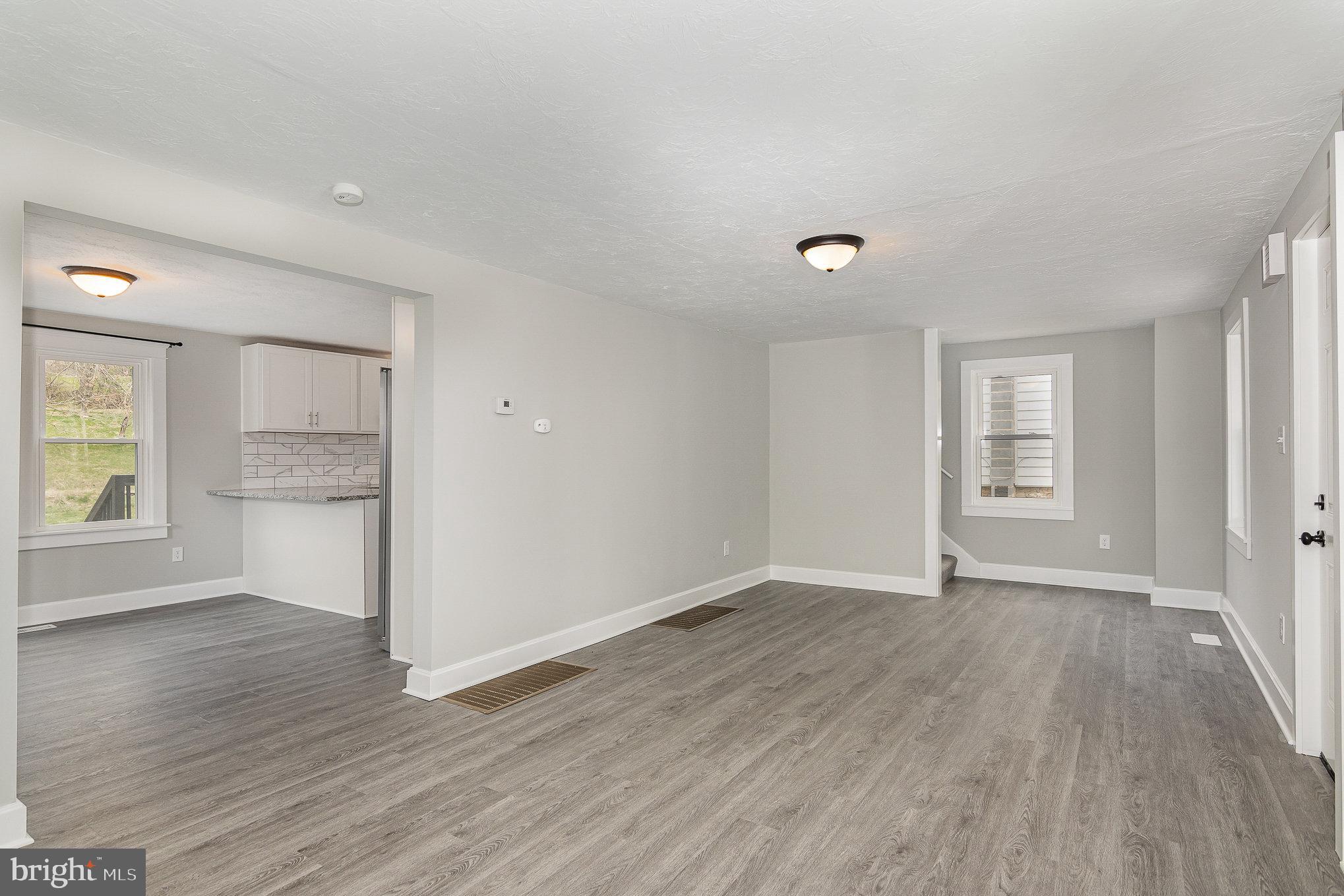 5495 Lehman Road Spring Grove, PA 17362 - Photo 6 of 34 a view of an empty room with wooden floor and a window