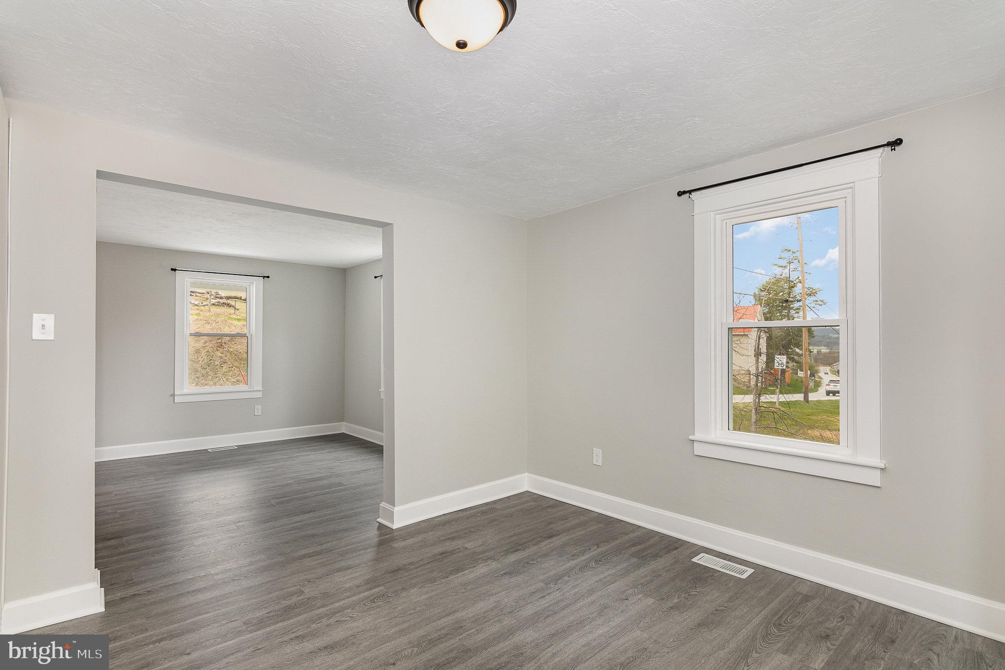 5495 Lehman Road Spring Grove, PA 17362 - Photo 8 of 34 a view of an empty room with wooden floor and a window