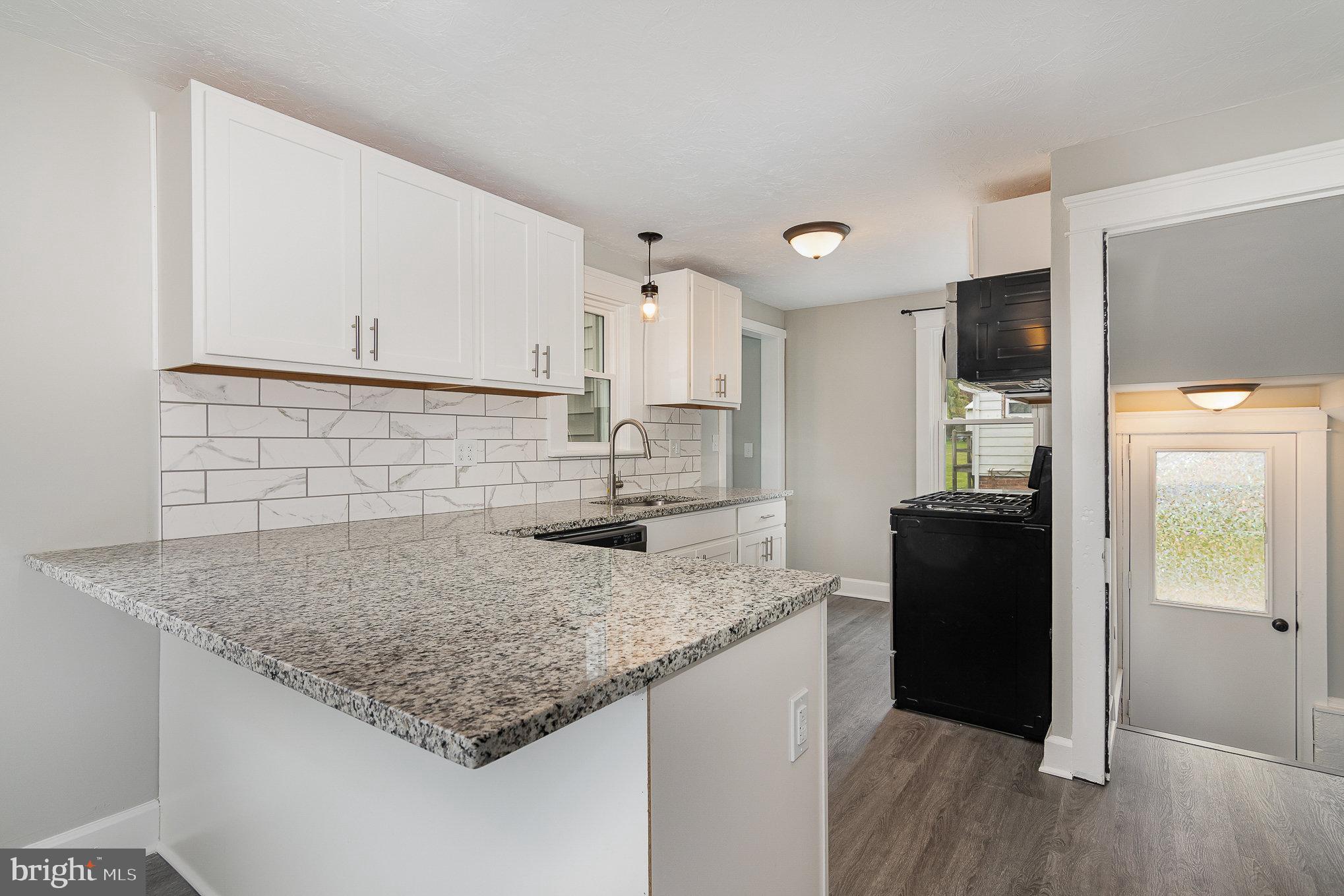 5495 Lehman Road Spring Grove, PA 17362 - Photo 9 of 34 a kitchen with kitchen island granite countertop a sink cabinets and refrigerator