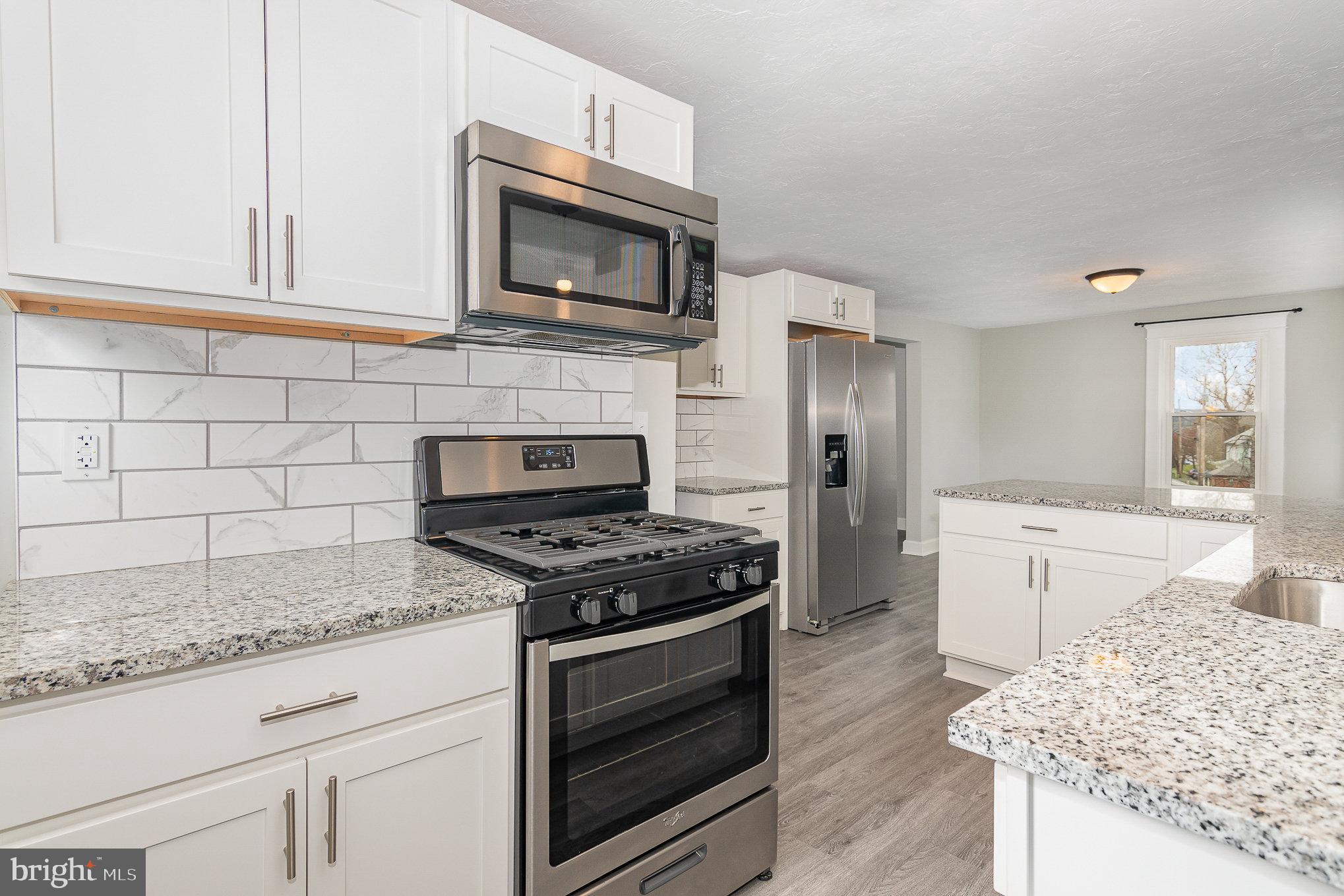 5495 Lehman Road Spring Grove, PA 17362 - Photo 10 of 34 a kitchen with granite countertop a stove and a sink