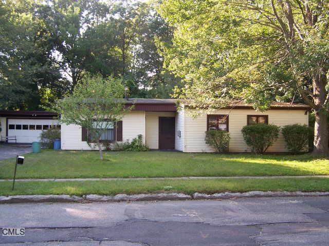 130 Carol Road Stratford, CT 06614 - Photo 1 of 1 a front view of a house with a garden and trees