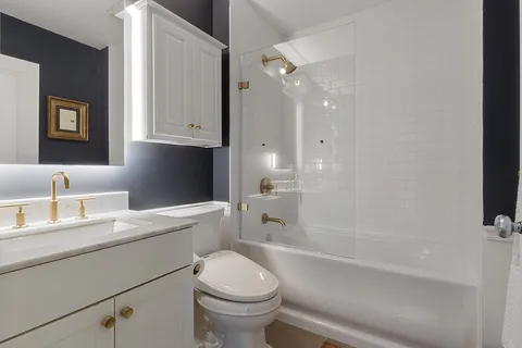 a bathroom with a sink a toilet and a bathtub