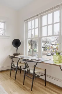 a view of a workspace room with furniture window and wooden floor