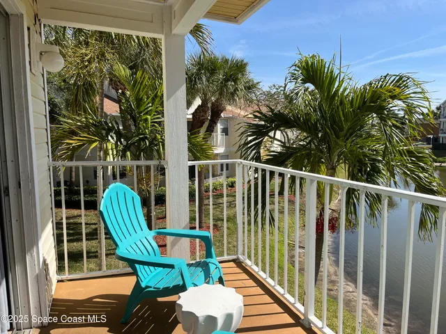 a view of a chair and table in the balcony